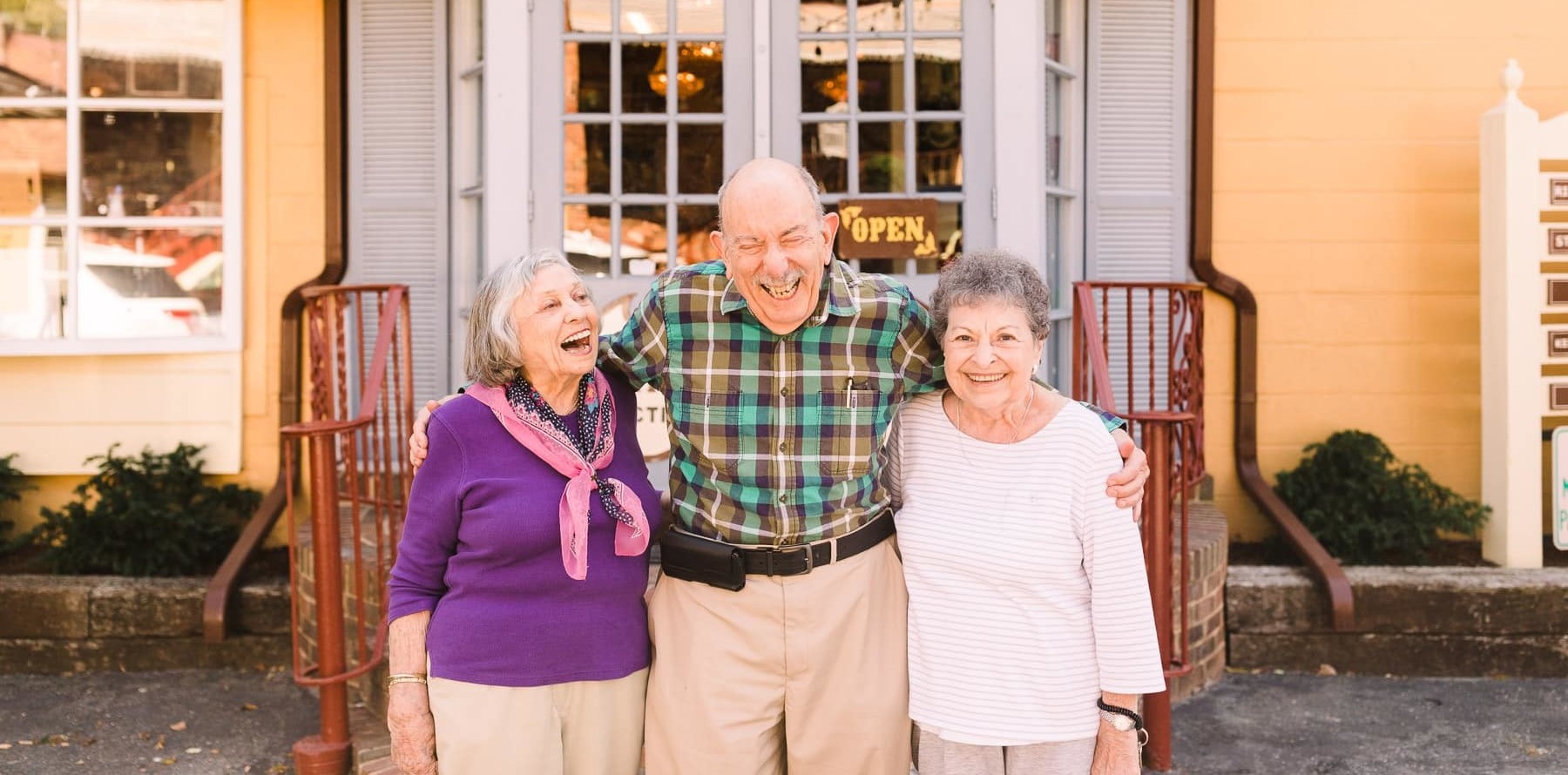 three seniors laughing outside together