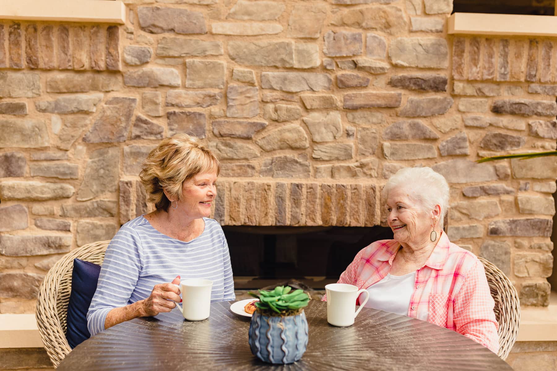 two elderly women drinking coffee
