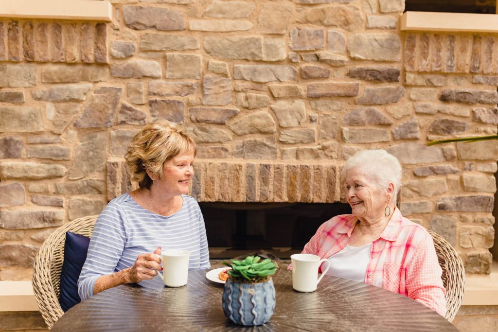 two elderly women drinking coffee