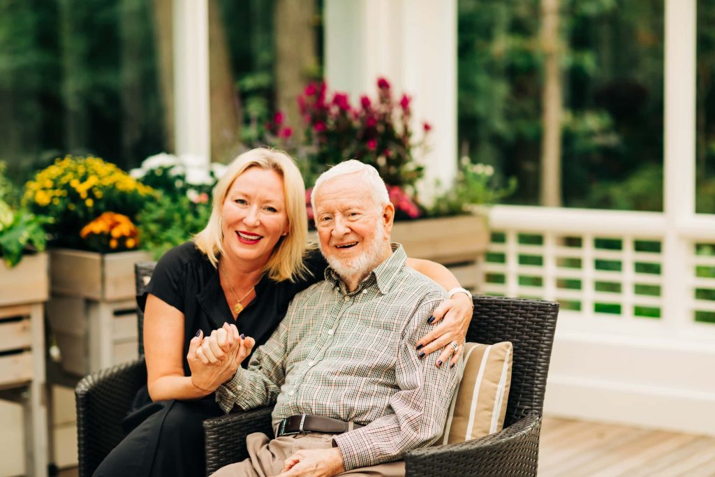 senior father and daughter holding hands outside