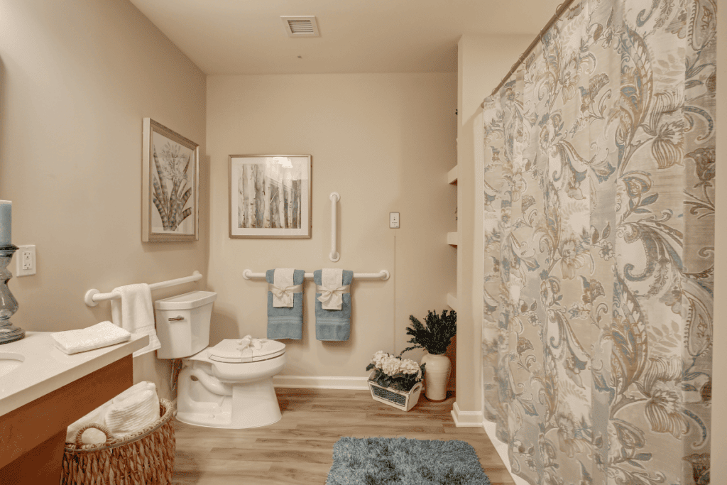 A bathroom with a shower curtain and a toilet.