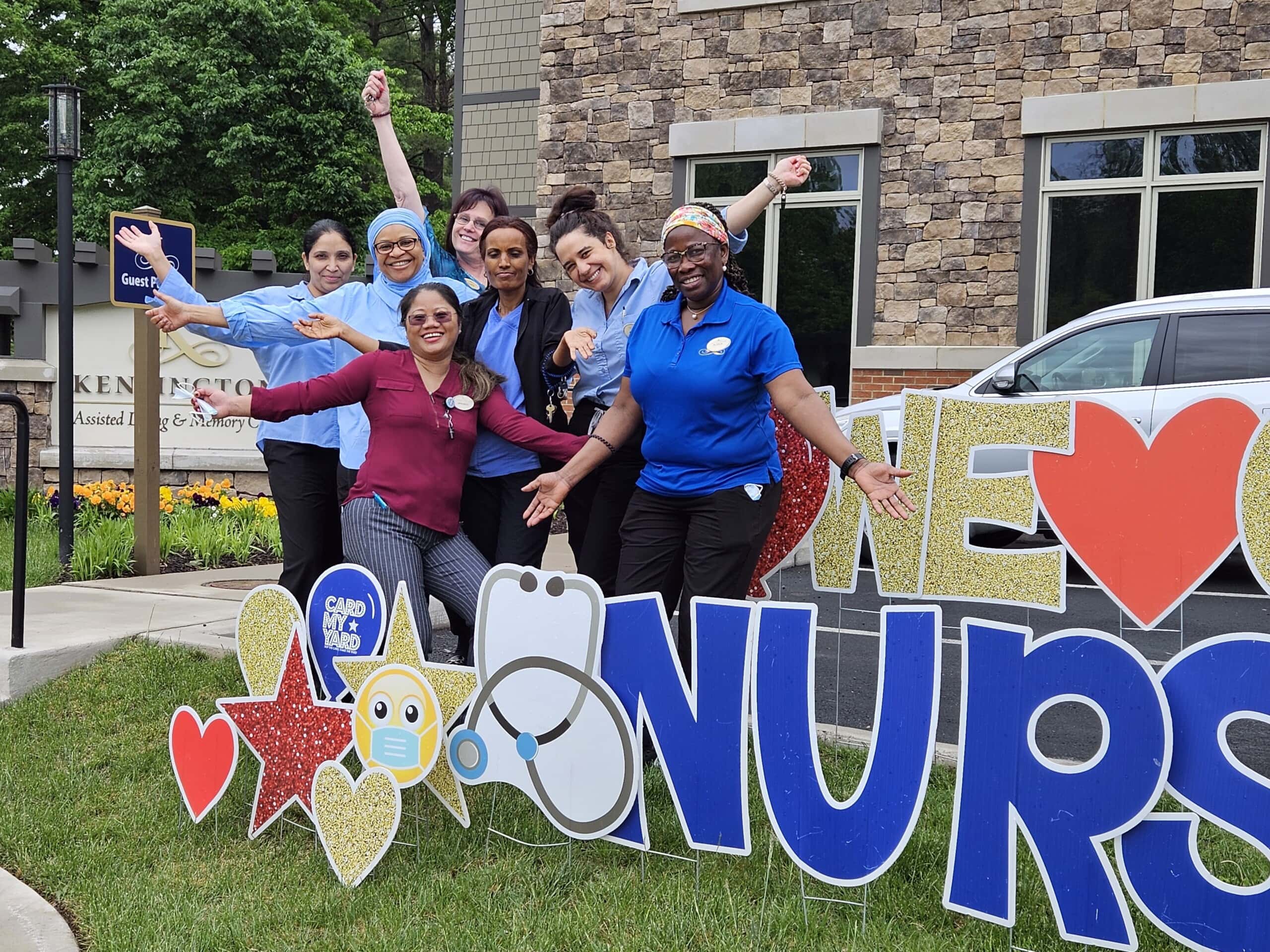 Nursing team standing by signs