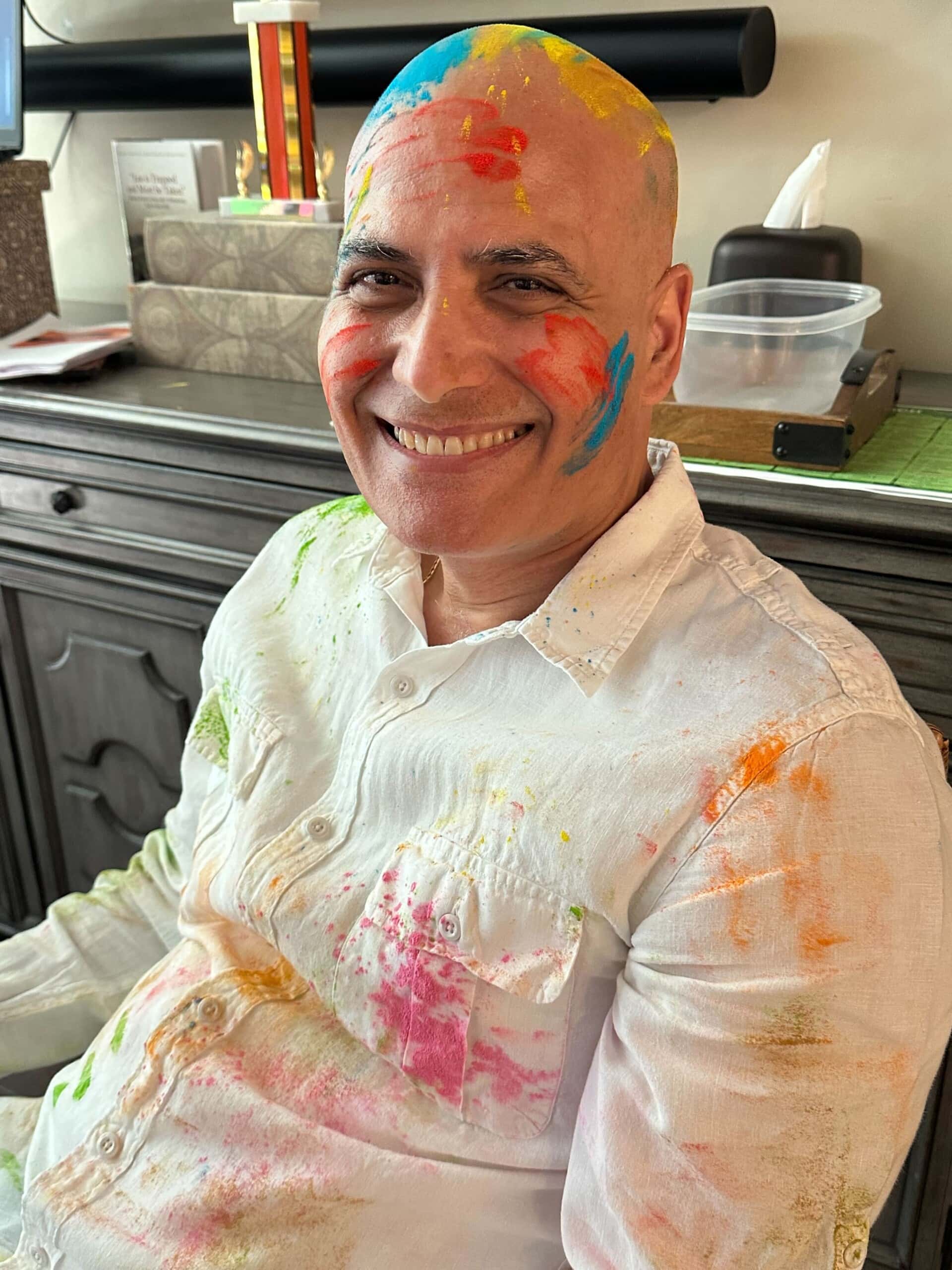 man with paint splattered on face and shirt