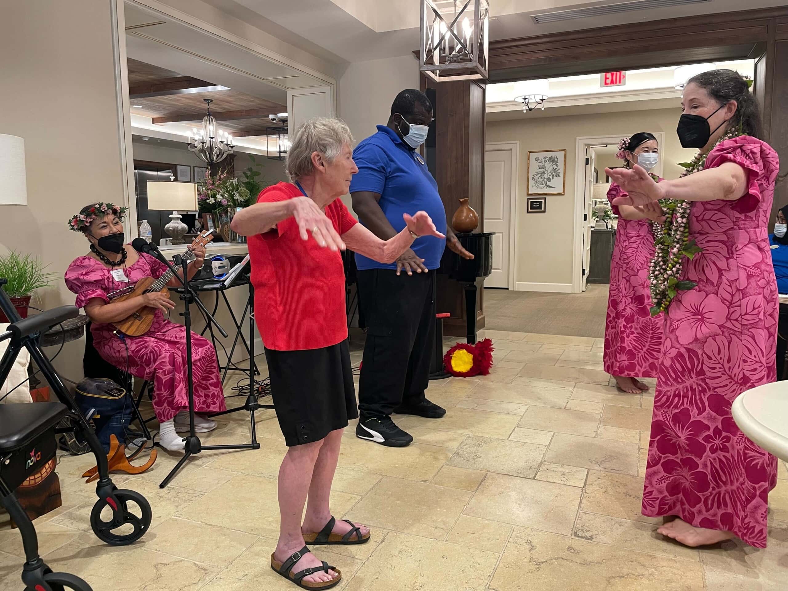 caregivers and elderly residents dancing