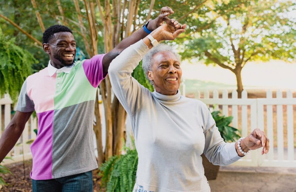 young adult man and older woman dancing