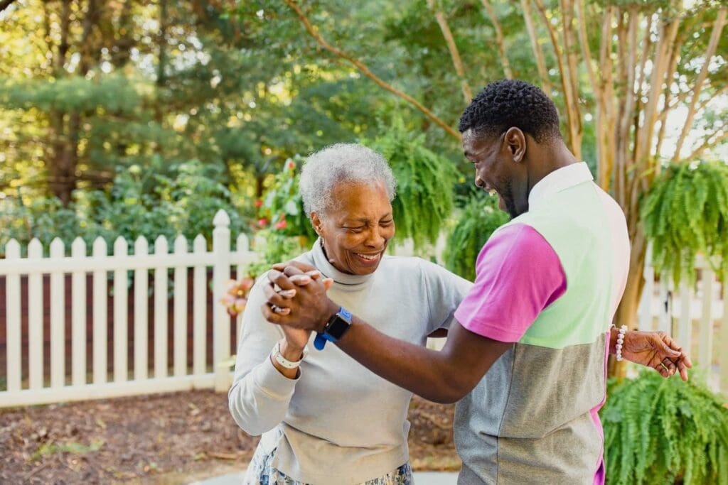 caregiver and resident dancing