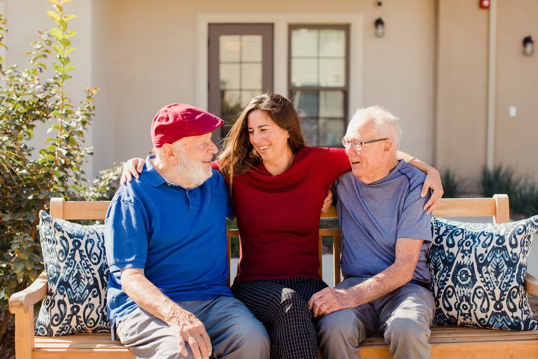 team member with two male residents laughing