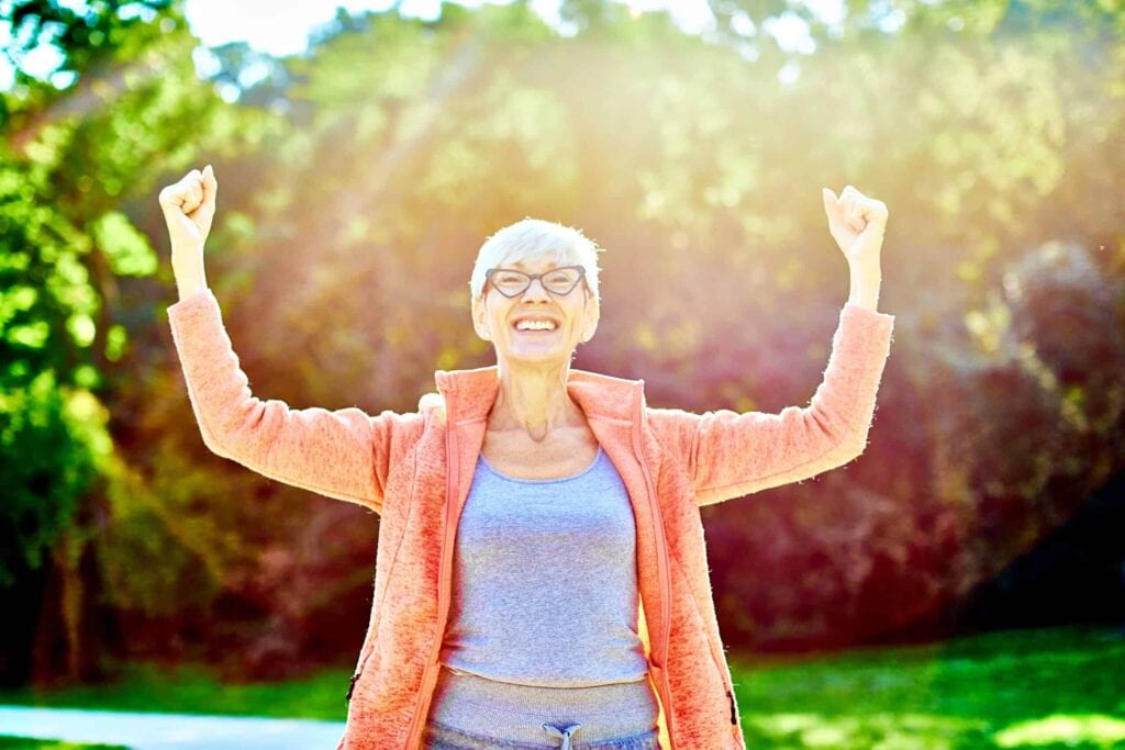 senior woman holding up arms