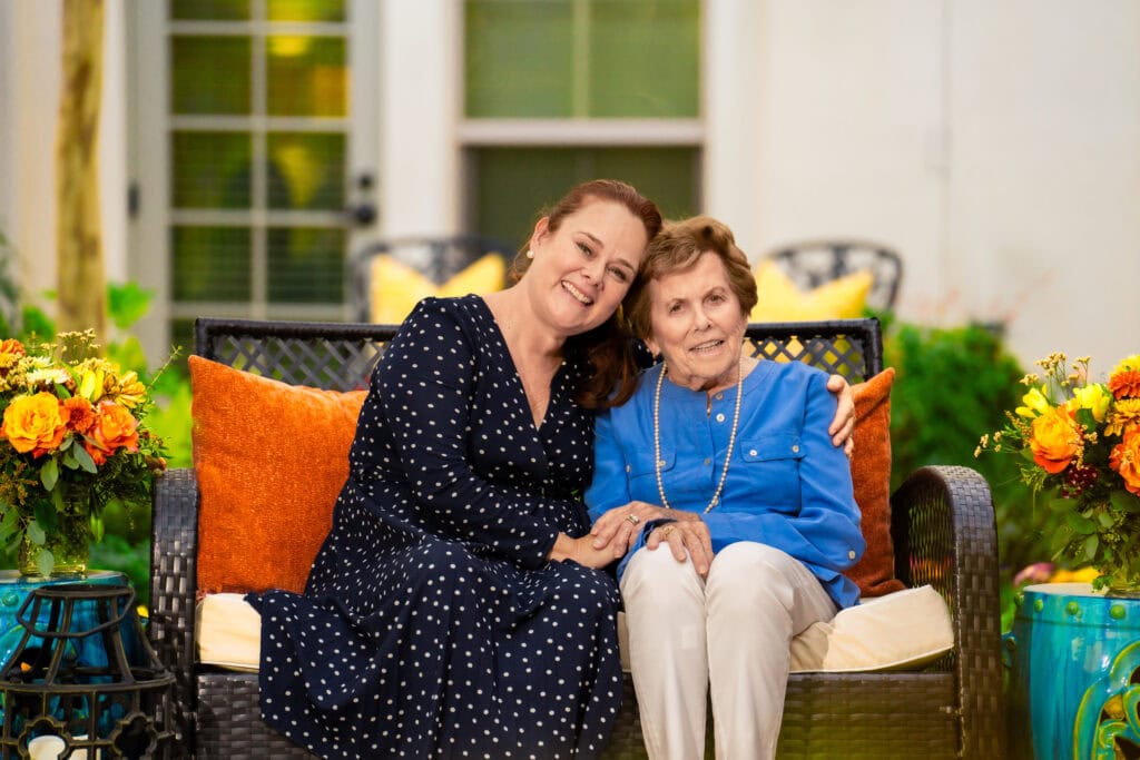 two women sitting on bench together