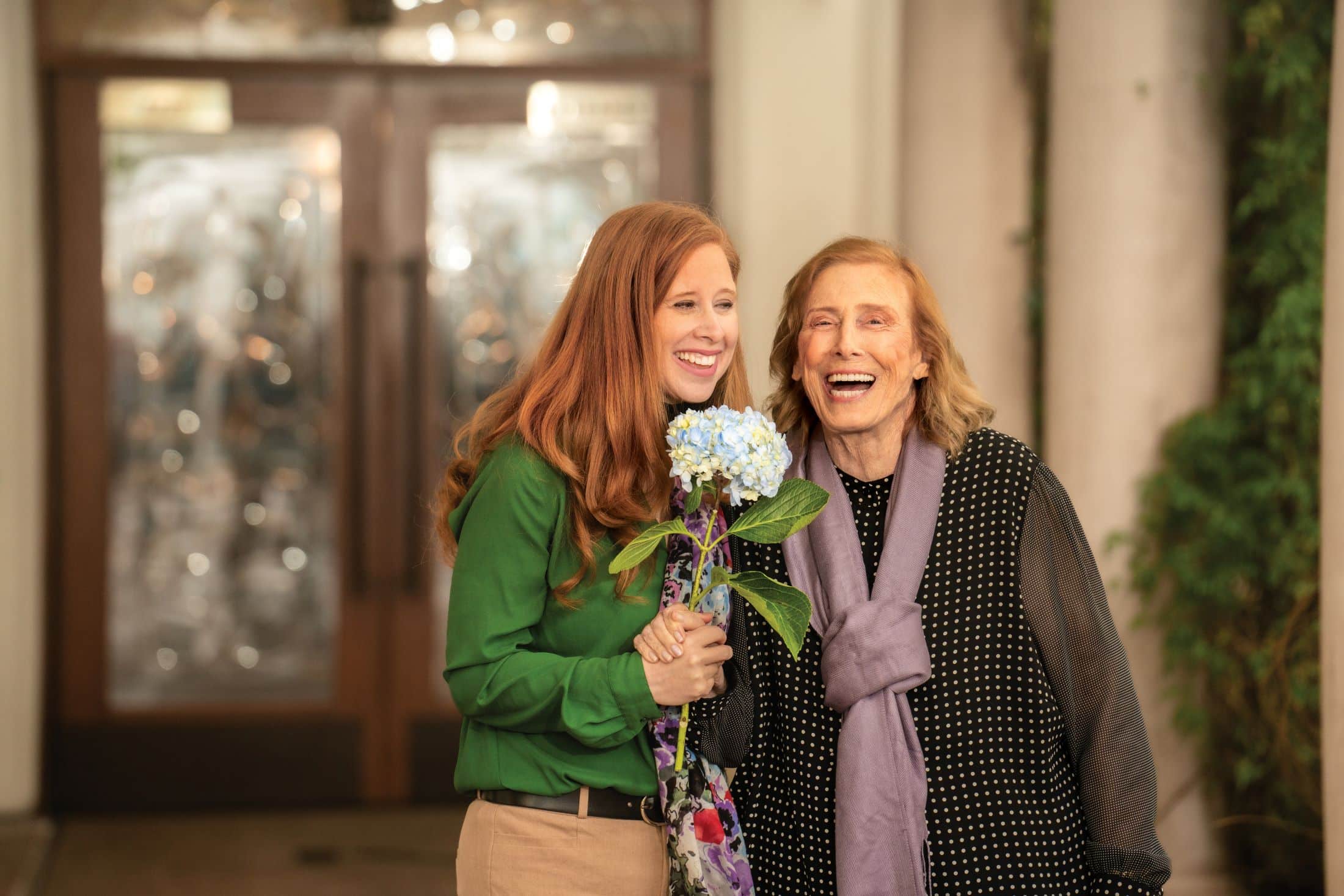 two ladies holding flowers