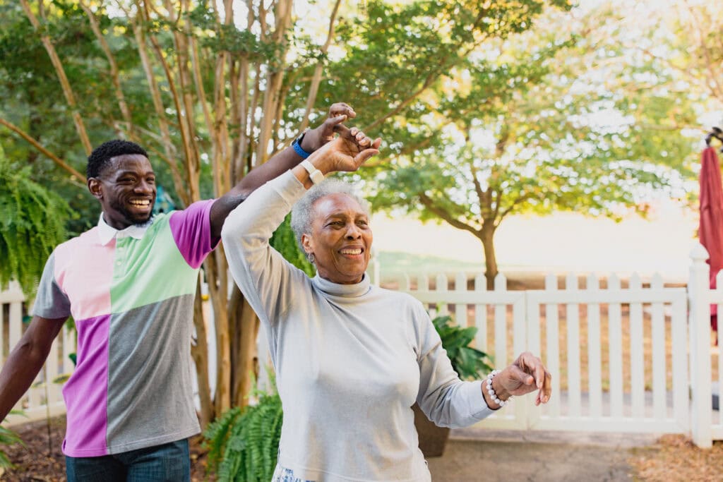young man and old woman dancing